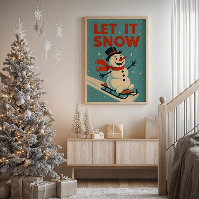 May include: A framed vintage poster with the text "LET IT SNOW" above a snowman on a sled. The snowman wears a black top hat and a red scarf. The poster is displayed above a wooden cabinet with a Christmas tree and decorations.