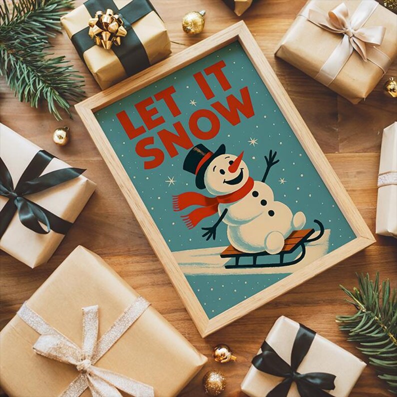 May include: A framed print featuring the words "LET IT SNOW" and a snowman illustration. The print is surrounded by wrapped gifts with ribbons and bows, pine branches, and gold baubles, creating a festive holiday scene.