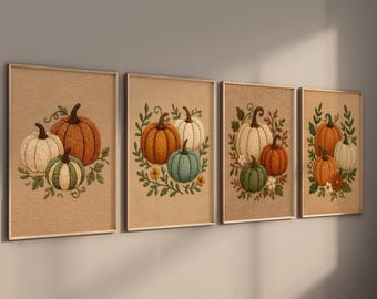 May include: A set of four framed wall art prints featuring embroidered-style illustrations of pumpkins in shades of orange, white, green, and blue, accented with green leaves and small flowers on a textured tan background within light wood frames.