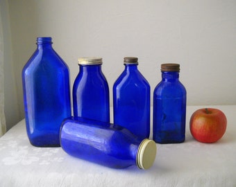 Cobalt blue glass bottles, vintage apothecary, drugstore, milk of magnesia medicine