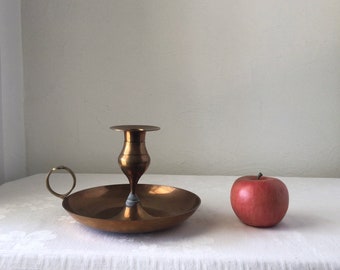 Large brass candleholder with handle and drip tray, vintage taper display