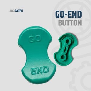 以下が含まれることがあります： 2つのティール色の「GO-END BUTTON」パーツ。1つは「GO」と「END」のテキストが入った完全な丸みを帯びた形状です。もう1つは、機械的なデザインの小さな分離したパーツです。「ADAGRI」のロゴが左上にあります。