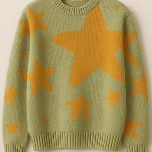 May include: A green knit sweater featuring a pattern of large and small yellow stars. The sweater has a crew neck and ribbed cuffs and hem. The star pattern is repeated across the front, back, and sleeves of the sweater.