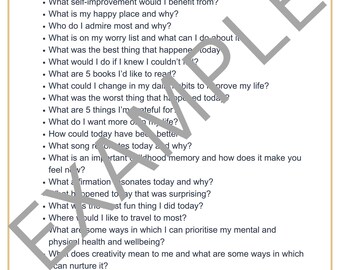 May include: A white paper with the title "Journal Prompts" and a list of questions for self-reflection. The questions are designed to encourage introspection and personal growth, covering topics like gratitude, fears, and aspirations.