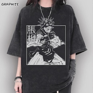 May include: Graphite-colored, oversized t-shirt featuring a black and white anime-style illustration within a white square. The graphic includes a character with spiky hair and Japanese text. The shirt has short sleeves and a crew neck.