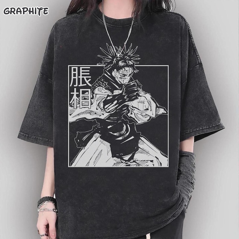 May include: Graphite-colored, oversized t-shirt featuring a black and white anime-style illustration within a white square. The graphic includes a character with spiky hair and Japanese text. The shirt has short sleeves and a crew neck.