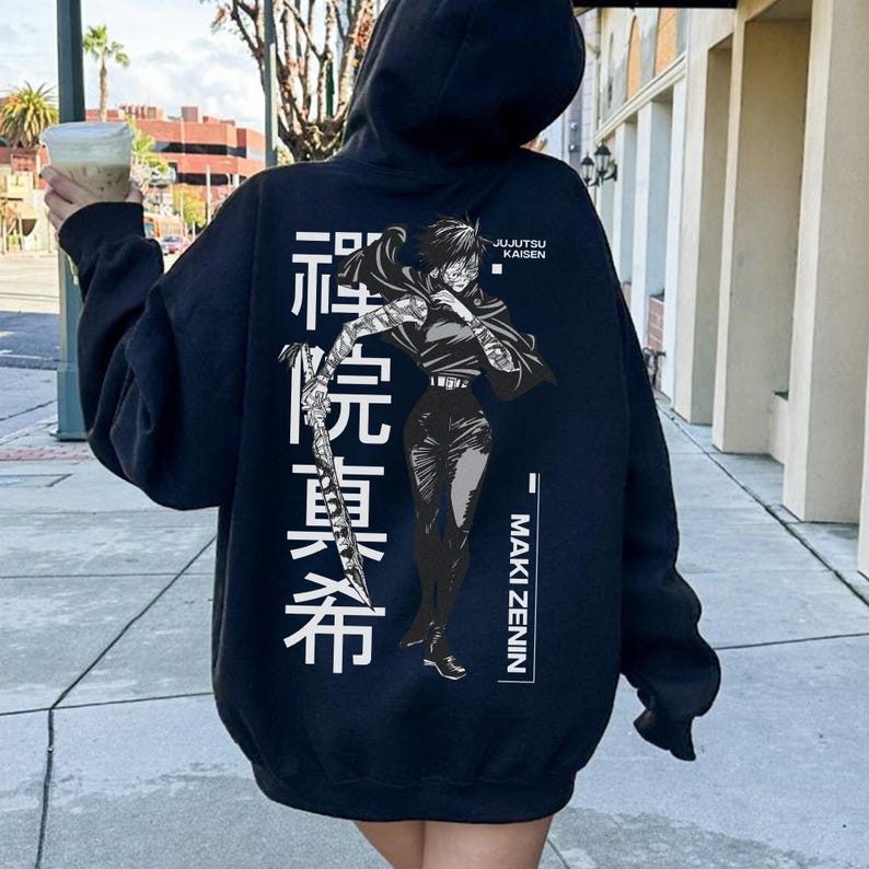 May include: Black hoodie featuring a graphic of a character from Jujutsu Kaisen, with Japanese text and the name Maki Zenin. The design is in white and gray, set against the dark fabric of the hooded sweatshirt.