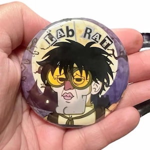 May include: A white ceramic mug with a black handle and the text "But First, Coffee" in a black, handwritten-style font. The mug is on a white surface.