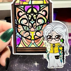May include: A sticker featuring a stained glass window design with a cat face. Beside it is a cartoon of an elderly woman with glasses, holding a white cat and a staff. The woman wears a yellow jacket and a long skirt.