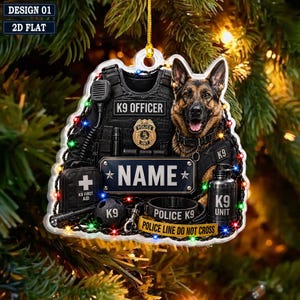May include: A flat, decorative ornament featuring a German Shepherd dog wearing a tactical vest labeled K9 OFFICER. The design includes a K9 first aid kit, a water bottle, a police collar, and a central nameplate. Multi-colored lights surround the items.