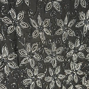 May include: Black fabric featuring a repeating floral design. Each flower is outlined and filled with white beads. The background is a solid black colour.
