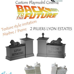 May include: Custom Playmobil Cinema set with a "Back to the Future" theme. The image shows two grey pillars with lion statues, the text "LYON ESTATES," and a miniature DeLorean car. The words "BACK TO THE FUTURE" are also displayed.