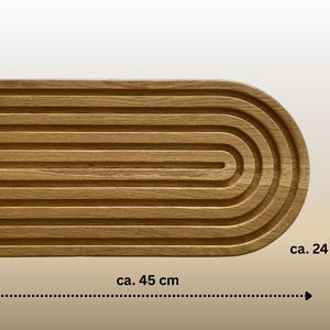 May include: A wooden serving tray with a grooved surface and a rounded end. The tray is approximately 17.7 inches long and 9.4 inches wide. The natural wood grain is visible, giving it a warm, rustic appearance.