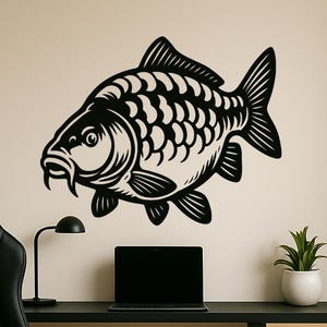 May include: Black carp fish wall art. The fish is a detailed silhouette, mounted on a cream wall. The image also shows a black desk, chair, a small lamp, a laptop, and a potted plant.