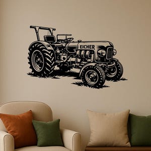 May include: Black metal wall art of a vintage tractor with the word "EICHER" on the hood. The tractor is depicted in a detailed silhouette, with large tires and a classic design. The art is mounted on a beige wall.