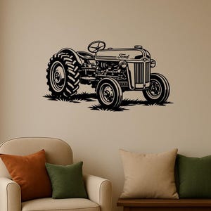 May include: Black metal wall art of a vintage Ford tractor. The tractor is depicted in profile, with large rear tires and a smaller front tire. The word "Ford" is visible on the hood. The tractor is set against a neutral background.