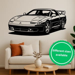 May include: Black and white wall decal of a sports car. The car is a sleek, low-profile design with a spoiler. The decal is mounted on a neutral-colored wall above a sofa. A green sticker with the text "Different sizes available" is visible.