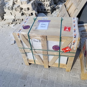 May include: A rectangular wooden shipping crate reinforced with diagonal support beams, wrapped in clear plastic film and secured with green plastic straps. The crate features FedEx branded adhesive tape, fragile warning labels, and shipping documents.