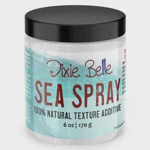 May include: A cylindrical container with a black lid containing Dixie Belle Sea Spray 100% natural texture additive. The label features a light blue ocean wave graphic, red text reading SEA SPRAY, and indicates a weight of 6 oz | 170 g.