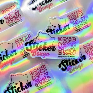 May include: A collection of iridescent holographic stickers with a cartoon cat design and the text "Sticker Bongo" and "custom stickers!" The stickers feature a QR code and are available in various shapes and sizes.