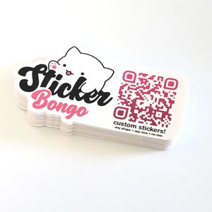 May include: A stack of white custom stickers with a pink and white cartoon cat and the text "Sticker Bongo". The stickers also feature a pink QR code with the text "custom stickers! any shape - any size - no min".