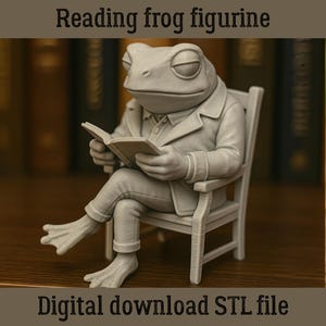 May include: A gray frog figurine seated in a chair, engrossed in reading a book. The frog is wearing a jacket and pants. The text "Reading frog figurine" and "Digital download STL file" are displayed.