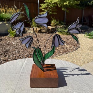 Stained glass blue bell flowers in wood base