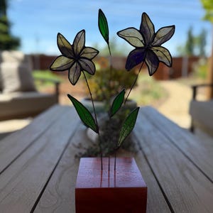Stained glass purple with yellow  lily flowers lillies in wood base