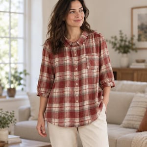 May include: A button-down shirt featuring a red, white, and gray plaid pattern. The shirt has a classic collar, three-quarter length sleeves with gathered cuffs, and a single chest pocket on the left side. The fabric has a textured appearance.