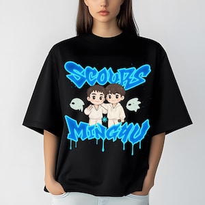 May include: Black t-shirt featuring a blue graffiti-style design with the words "SCOUPS" and "MINGYU". The graphic includes cartoon illustrations of two figures and ghost-like shapes.