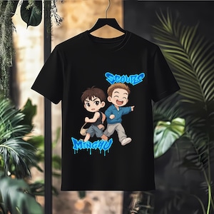 May include: Black t-shirt featuring a cartoon illustration of two animated figures with the text "SCOUPS" and "MINGYU" in blue graffiti-style lettering. The figures are depicted in a dynamic pose, suggesting movement.