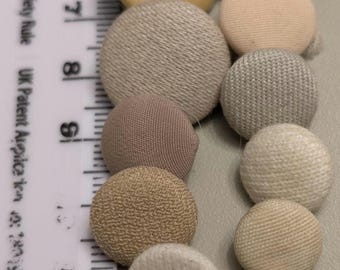 23 pastel creams peach and light browns fabric buttons with a shank