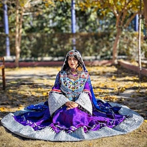 Traditional Afghan Kuchi Dress – Handcrafted Purple Embroidered Gown with Mirror Work & Jewelry Detailing