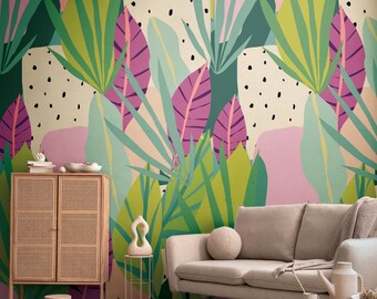 May include: A vibrant, colorful wallpaper featuring a tropical leaf design in shades of green, pink, and purple. The background has a cream color with black polka dots. A light wood cabinet, a beige sofa, and a small round table are in the foreground.