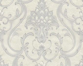 May include: Cream-colored wallpaper with a repeating pattern of ornate, silver-gray floral and scroll designs. The wallpaper has a textured, slightly crackled appearance, adding depth to the elegant, classic design.