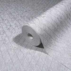 May include: A roll of textured, light gray wallpaper with a diamond pattern. The wallpaper is partially unrolled, revealing the pattern and texture. The design features a grid of diamond shapes with a subtle, mottled effect.