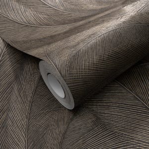 May include: A roll of wallpaper featuring a large feather design in shades of brown and beige. The feathers have detailed veining, creating a textured appearance. The roll is partially unrolled, revealing the paper's pattern.