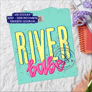 May include: A turquoise t-shirt with the words "RIVER BABE" in yellow and pink, with colorful paint splatter accents. The shirt has a crew neck and short sleeves. The words "HIGH RESOLUTION", "3600PX", "300DPI PNG DOWNLOAD", and "TRANSPARENT BACKGROUND" are also visible.