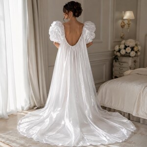 Elegant floor-length bridal robe with dramatic puff sleeves crafted from lightweight sheer fabric. Romantic wedding robe available in white and champagne, perfect for bridal getting ready photos, honeymoon, bridal boudoir, and luxury wedding morning styling.