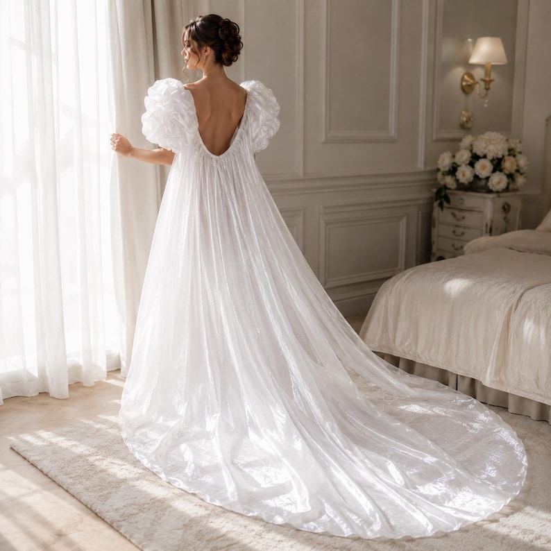 Elegant floor-length bridal robe with dramatic puff sleeves crafted from lightweight sheer fabric. Romantic wedding robe available in white and champagne, perfect for bridal getting ready photos, honeymoon, bridal boudoir, and luxury wedding morning styling.