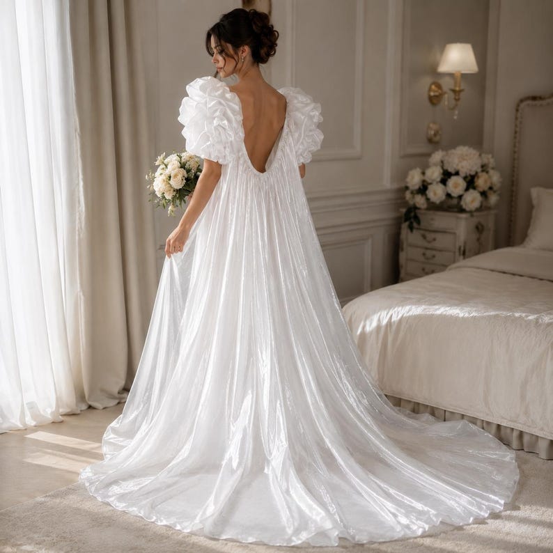 Elegant floor-length bridal robe with dramatic puff sleeves crafted from lightweight sheer fabric. Romantic wedding robe available in white and champagne, perfect for bridal getting ready photos, honeymoon, bridal boudoir, and luxury wedding morning styling.
