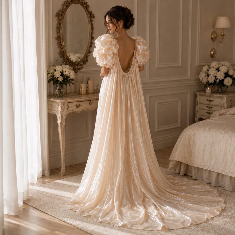 Elegant floor-length bridal robe with dramatic puff sleeves crafted from lightweight sheer fabric. Romantic wedding robe available in white and champagne, perfect for bridal getting ready photos, honeymoon, bridal boudoir, and luxury wedding morning styling.