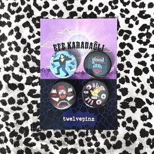 May include: Four pin badges with different designs. One shows a person with birds, another says "good together" with a brain graphic, a third says "shapeshifter", and the last says "far out". The card reads "EFE KARADAGLI" and "twelvepinz".