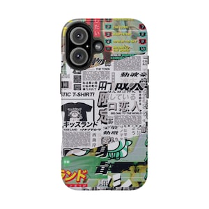 May include: A phone case with a collage design featuring Japanese text, English words, and graphic elements. The case has a black camera lens cutout and a glossy finish. The design includes the words "KISS LAND" and "BELONG TO THE WORLD".