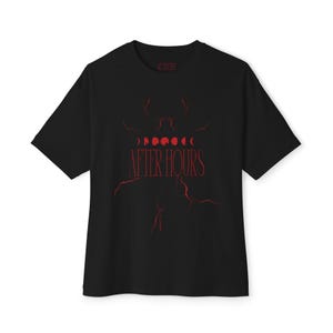 May include: Black t-shirt with a red graphic design. The design includes a series of moon phases above the words "AFTER HOURS" in a stylized font. The shirt has short sleeves and a crew neck.