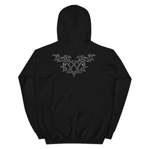 May include: A black hooded sweatshirt featuring a white graphic on the back. The design consists of a heart shape intertwined with a pentagram, surrounded by symmetrical, ornate, vine-like flourishes extending outward from the top of the heart.