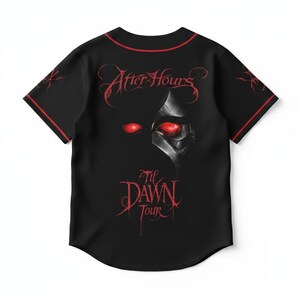 May include: A black short-sleeve button-down jersey with red piping along the collar and sleeves. The front features the red text After Hours Til Dawn Tour and a graphic of a metallic mask with glowing red eyes centered on the chest.