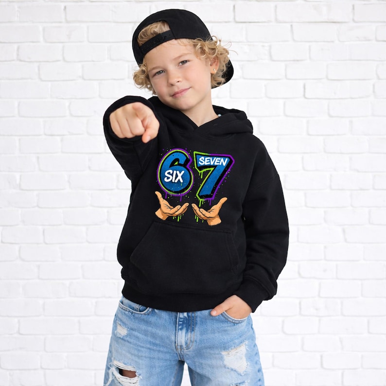 May include: Black hooded sweatshirt with the numbers "67" in blue and green, and the word "SIX" in a circle. The sweatshirt has a front pocket and is worn by a person wearing a black baseball cap and blue jeans.