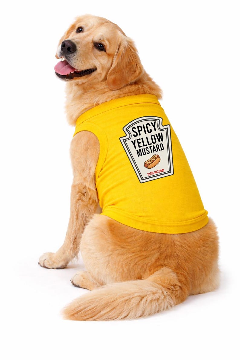 May include: A golden retriever wearing a bright yellow sleeveless pet shirt. The back of the shirt features a white label graphic with a black border, black text reading SPICY YELLOW MUSTARD, a hot dog illustration, and the text 100% NATURAL.