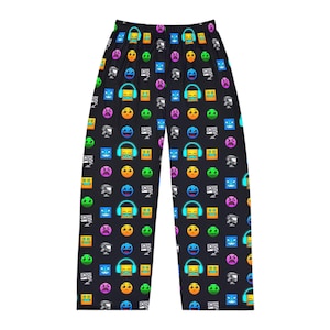 May include: Black pajama pants with a repeating pattern of colorful geometric shapes and emoji-like faces. The design includes squares, circles, and other shapes in various colors, creating a playful and vibrant look.